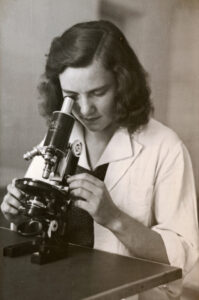 Donne nel pharma: foto di donna con microscopio, anni '50
